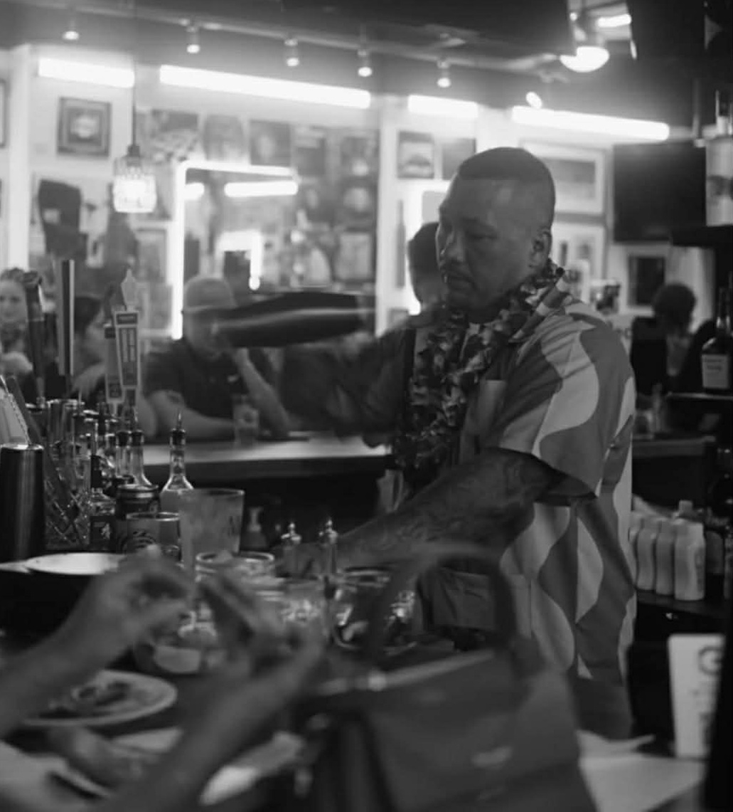 Bartender at Vintage Barbershop Bar Honolulu Hawaii — craft cocktails