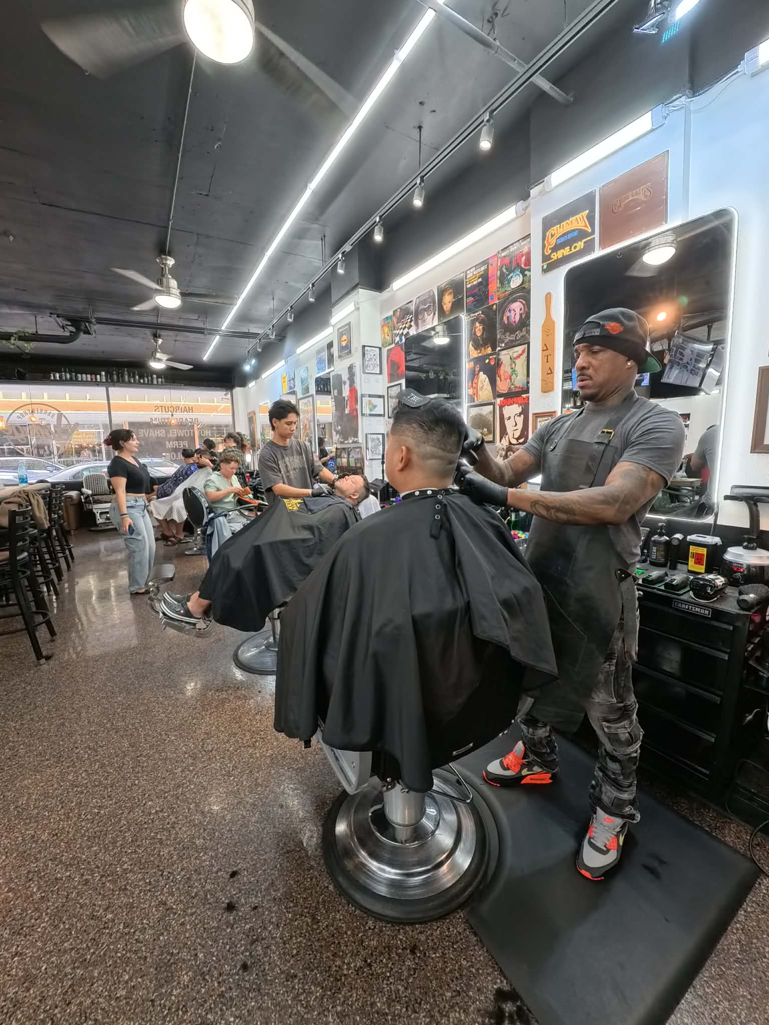 Busy barbershop Honolulu — multiple barbers working at Vintage Barbershop Hawaii