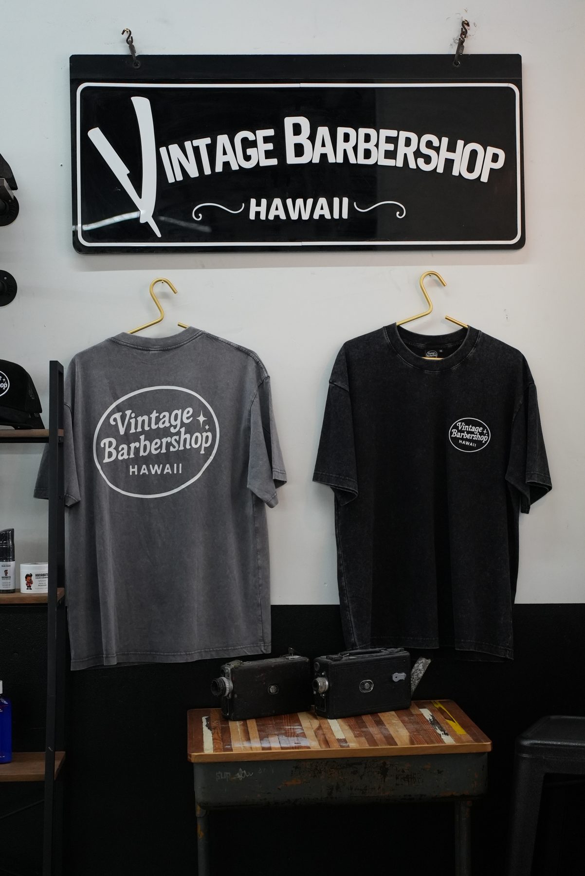 Vintage Barbershop Hawaii logo sign and clothing merch shirts inside the Downtown Honolulu shop